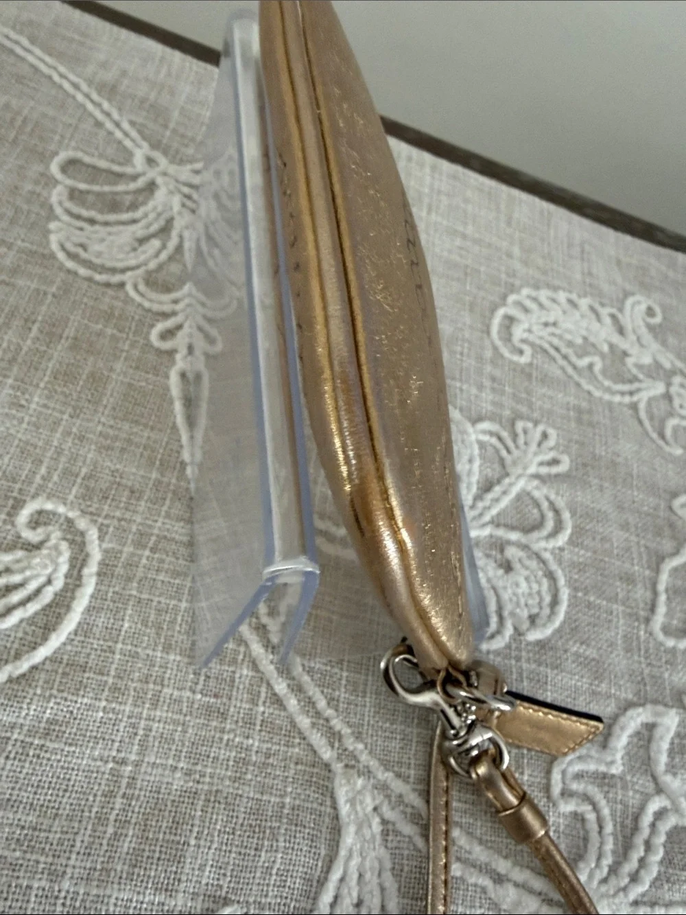 Coach Metallic Gold Wristlet with Embossed Chain Motif